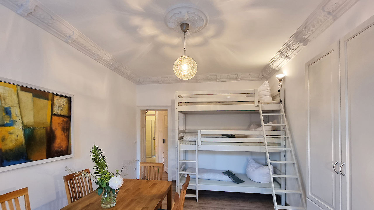 Family Apartment - living room with bunk bed and table